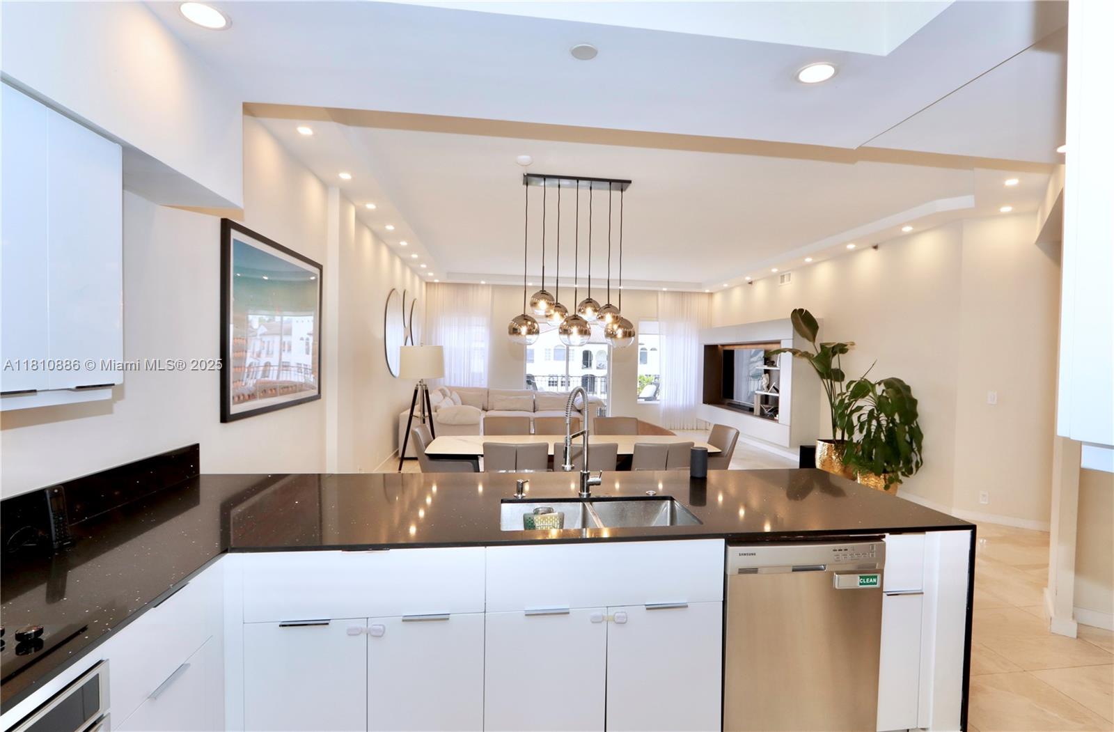 3900 Island Boulevard, Unit PH2 Aventura, FL 33160 - Photo 11 of 39 a kitchen with counter top space and living room