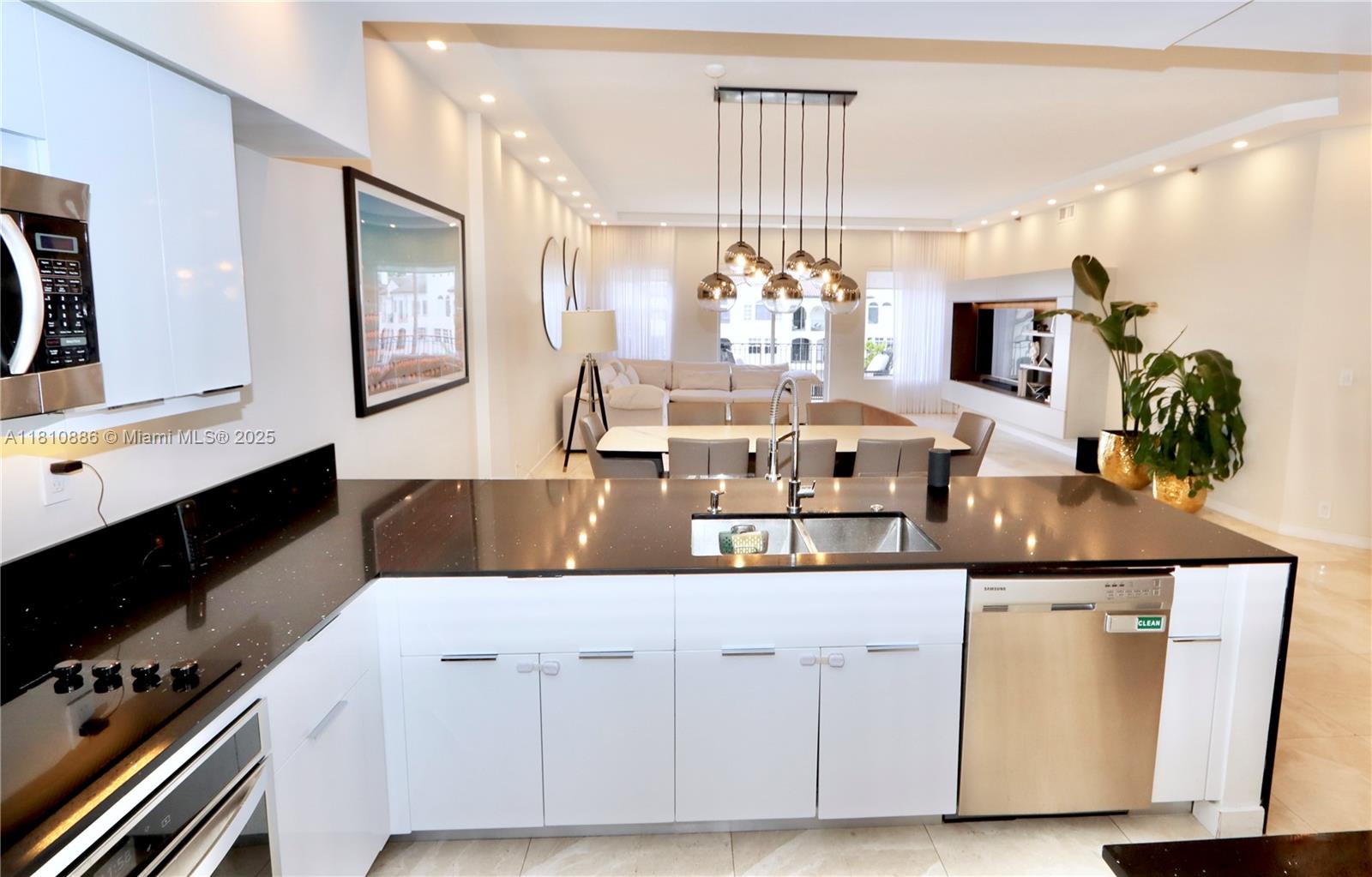 3900 Island Boulevard, Unit PH2 Aventura, FL 33160 - Photo 12 of 39 a living room with kitchen island granite countertop furniture and a flat screen tv