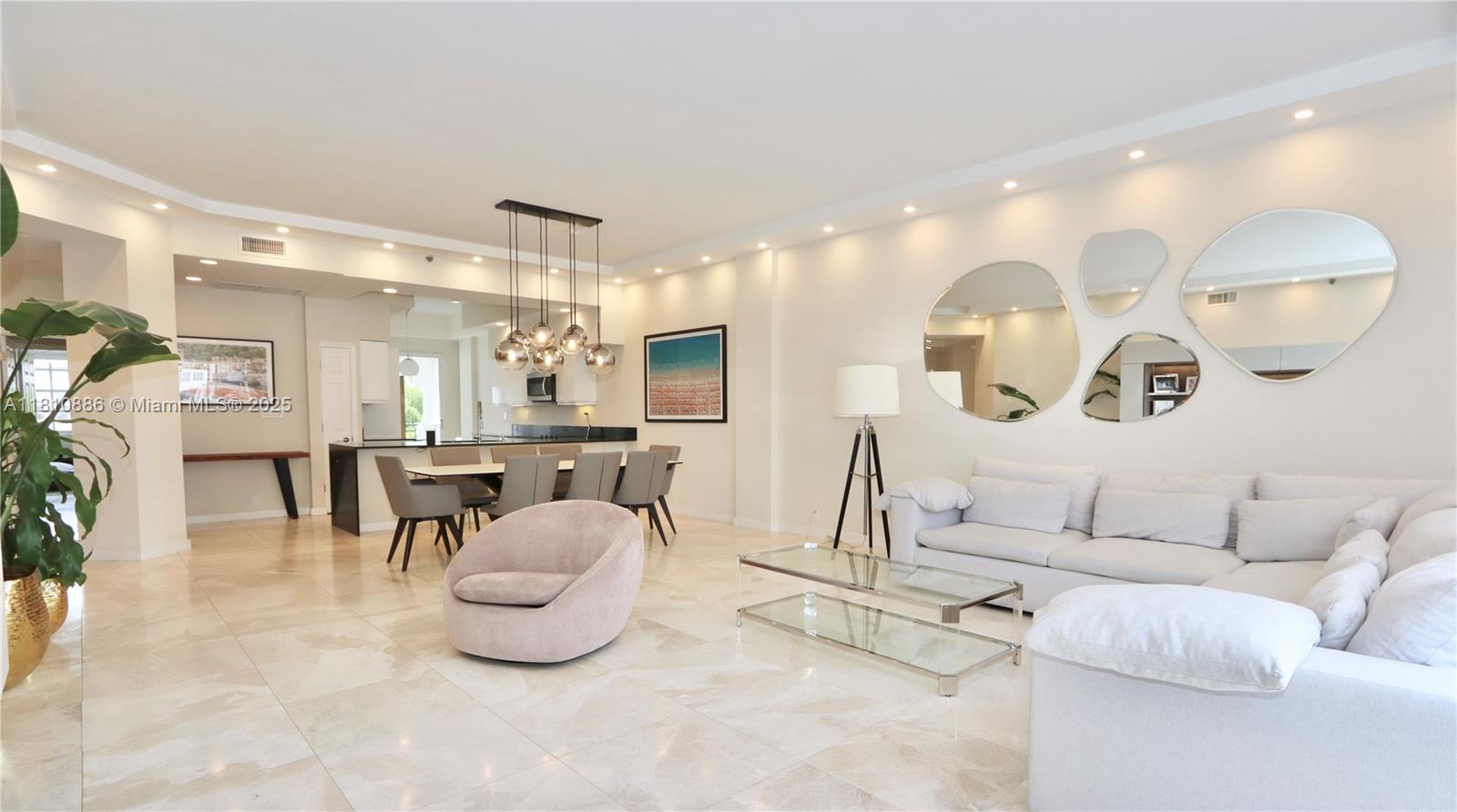 3900 Island Boulevard, Unit PH2 Aventura, FL 33160 - Photo 15 of 39 a living room with furniture and a chandelier