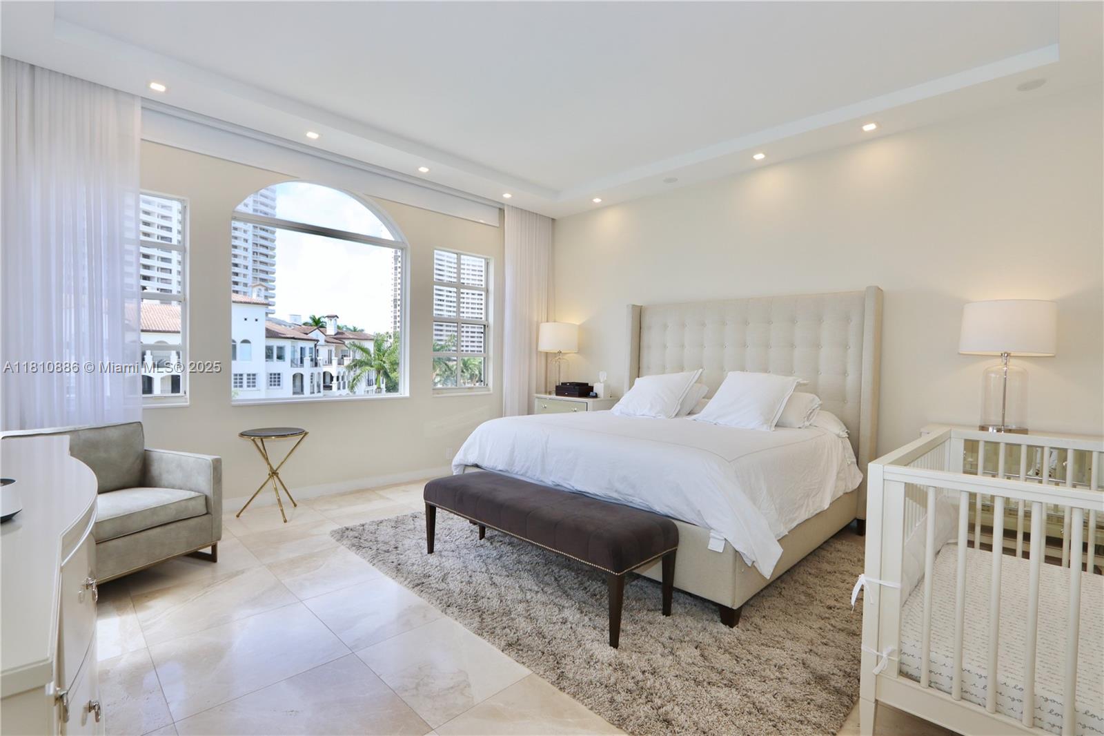 3900 Island Boulevard, Unit PH2 Aventura, FL 33160 - Photo 17 of 39 a spacious bedroom with a bed and a large window