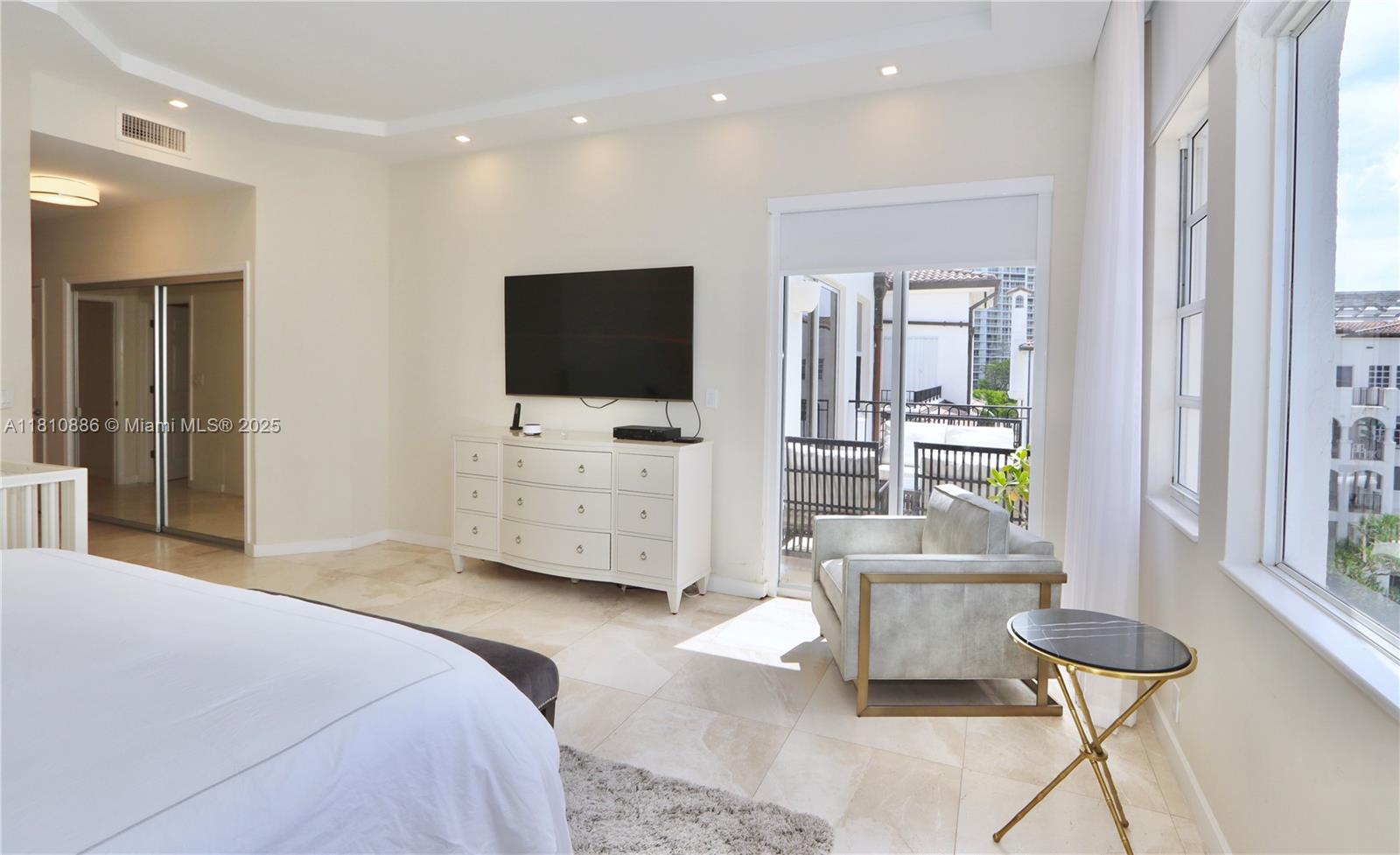 3900 Island Boulevard, Unit PH2 Aventura, FL 33160 - Photo 19 of 39 a bedroom with furniture and a flat screen tv