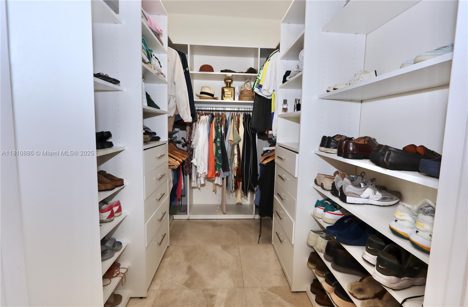 3900 Island Boulevard, Unit PH2 Aventura, FL 33160 - Photo 20 of 39 a view of walk in closet with clothes and shoes