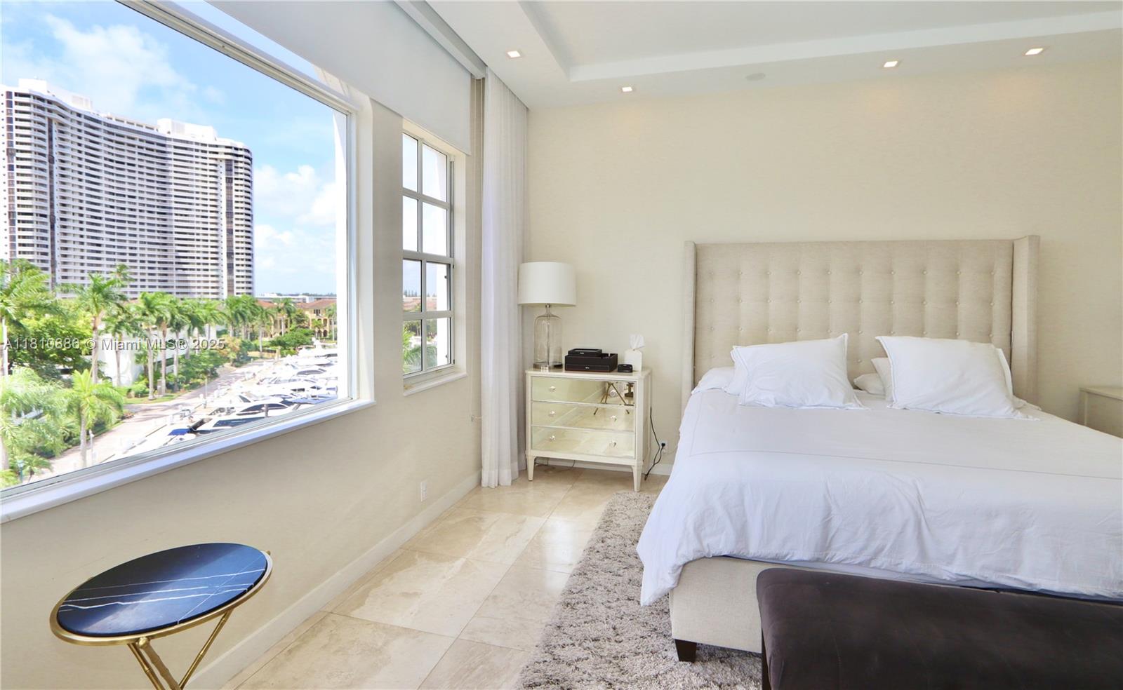 3900 Island Boulevard, Unit PH2 Aventura, FL 33160 - Photo 24 of 39 a bedroom with a bed dresser and a large window