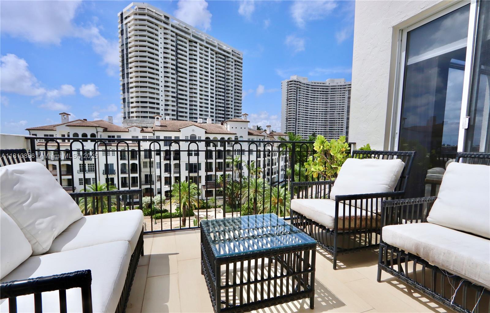 3900 Island Boulevard, Unit PH2 Aventura, FL 33160 - Photo 30 of 39 a balcony with table and chairs