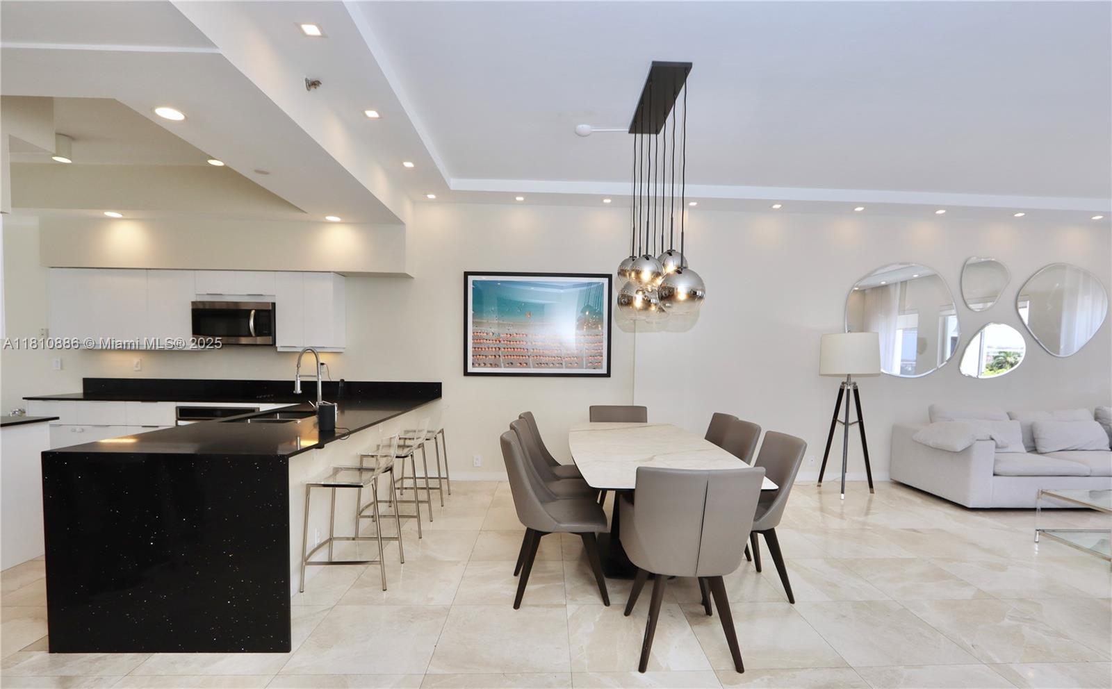 3900 Island Boulevard, Unit PH2 Aventura, FL 33160 - Photo 3 of 39 a dining room with furniture and wooden floor