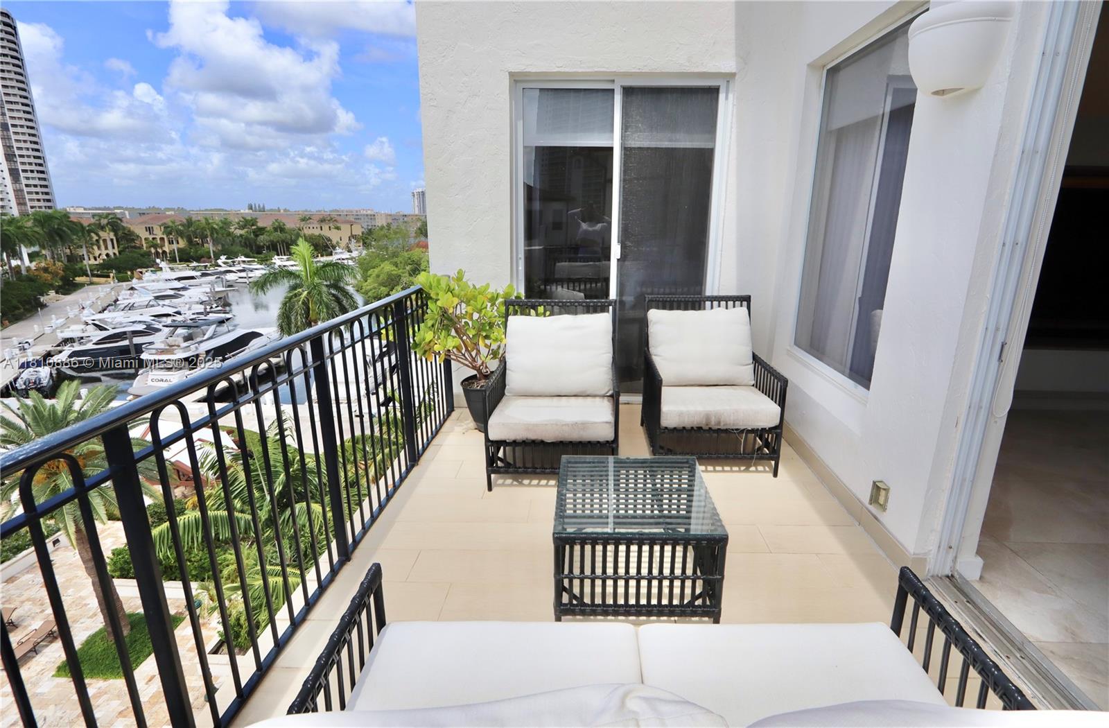 3900 Island Boulevard, Unit PH2 Aventura, FL 33160 - Photo 33 of 39 a balcony with chairs and a table