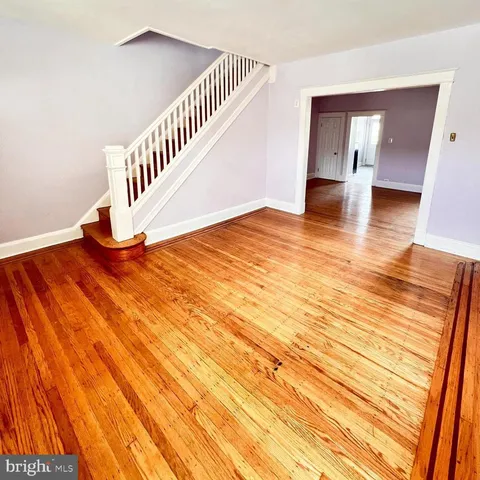 a view of an empty room and wooden floor