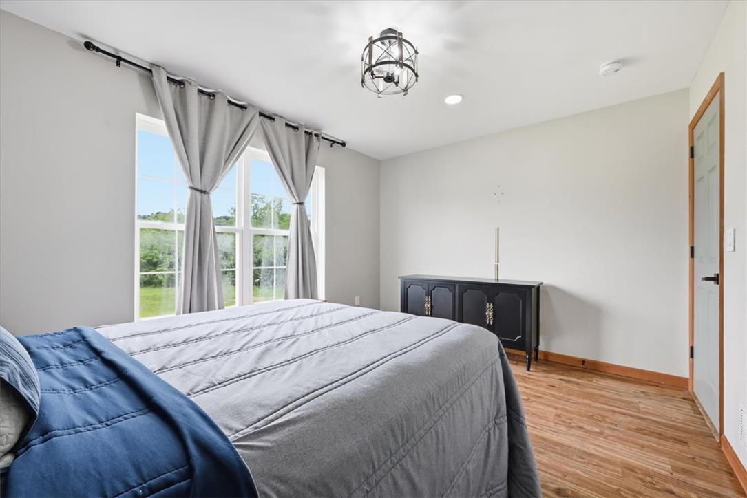 387 Blue Ridge Road Saylorsburg, PA 18353 - Photo 66 of 90 Brightly lit bedroom with abundant natural light through large windows and warm wood flooring.