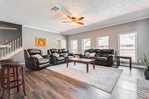 a spacious bedroom with a bed and a ceiling fan