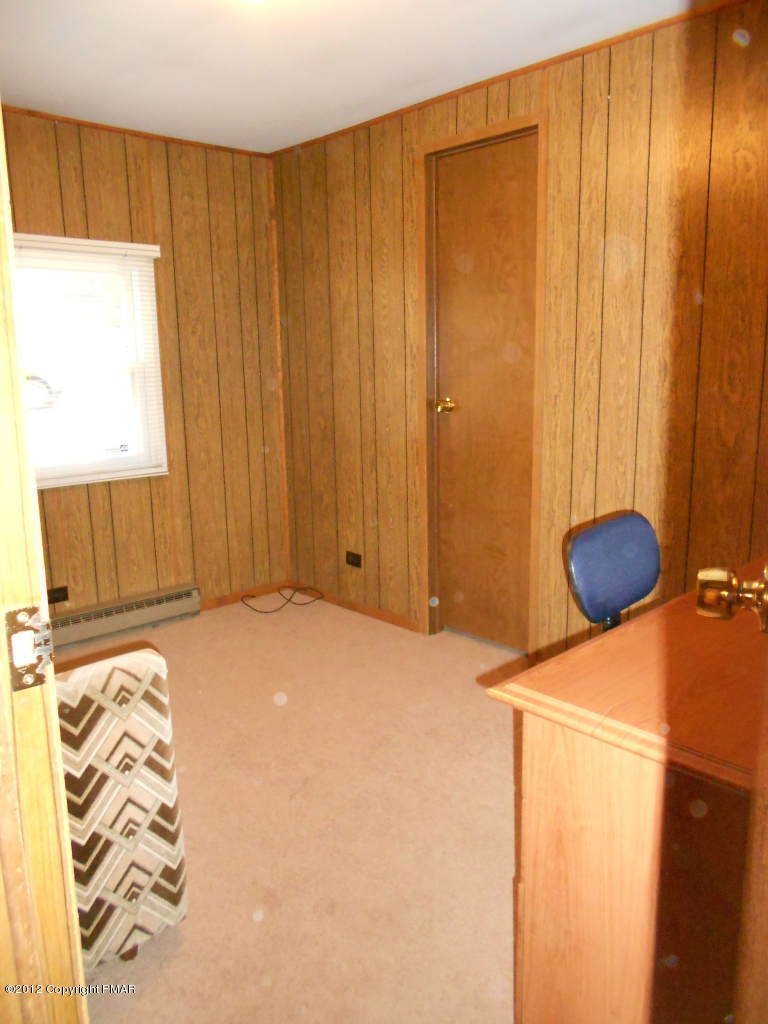 338 Summit Road Swiftwater, PA 18370 - Photo 12 of 15 a bedroom with a bed and a chair