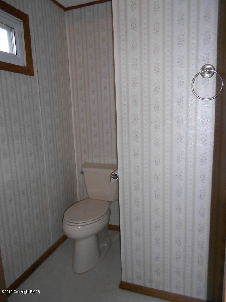 338 Summit Road Swiftwater, PA 18370 - Photo 14 of 15 a white toilet sitting next to a shower curtain