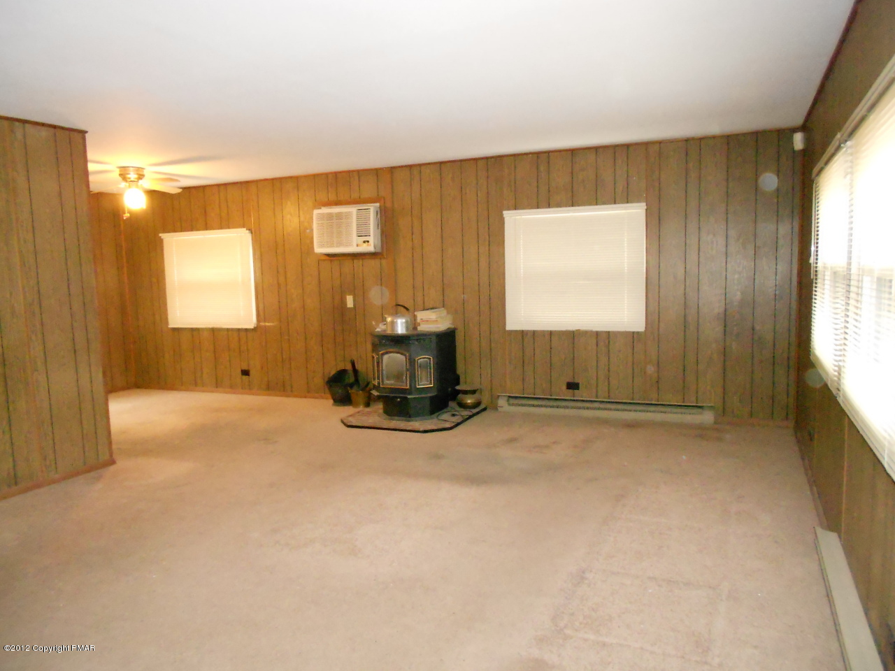 338 Summit Road Swiftwater, PA 18370 - Photo 7 of 15 a view of an empty room with a fireplace and a window