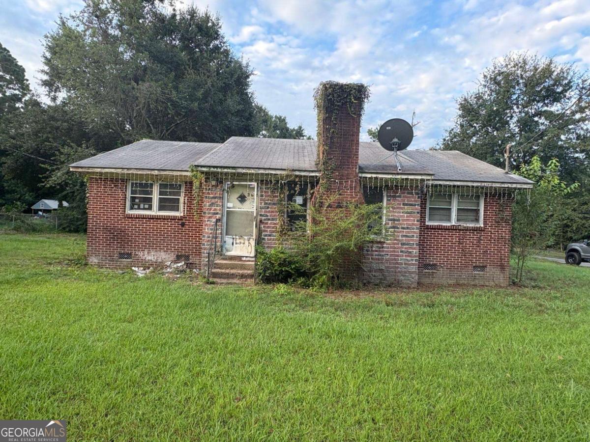 a front view of house with yard and green space