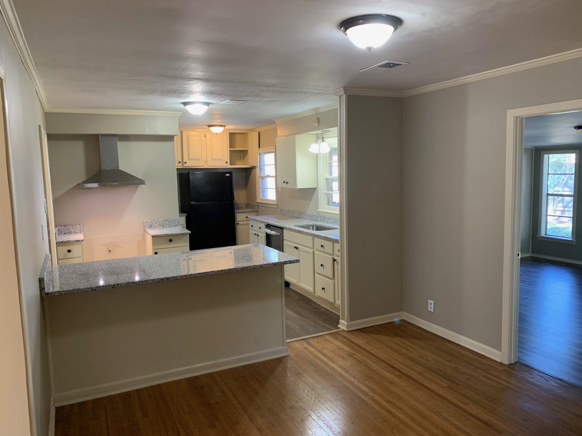 1640 South Perkins Road Memphis, TN 38117 - Photo 3 of 10 an empty room with wooden floor and windows