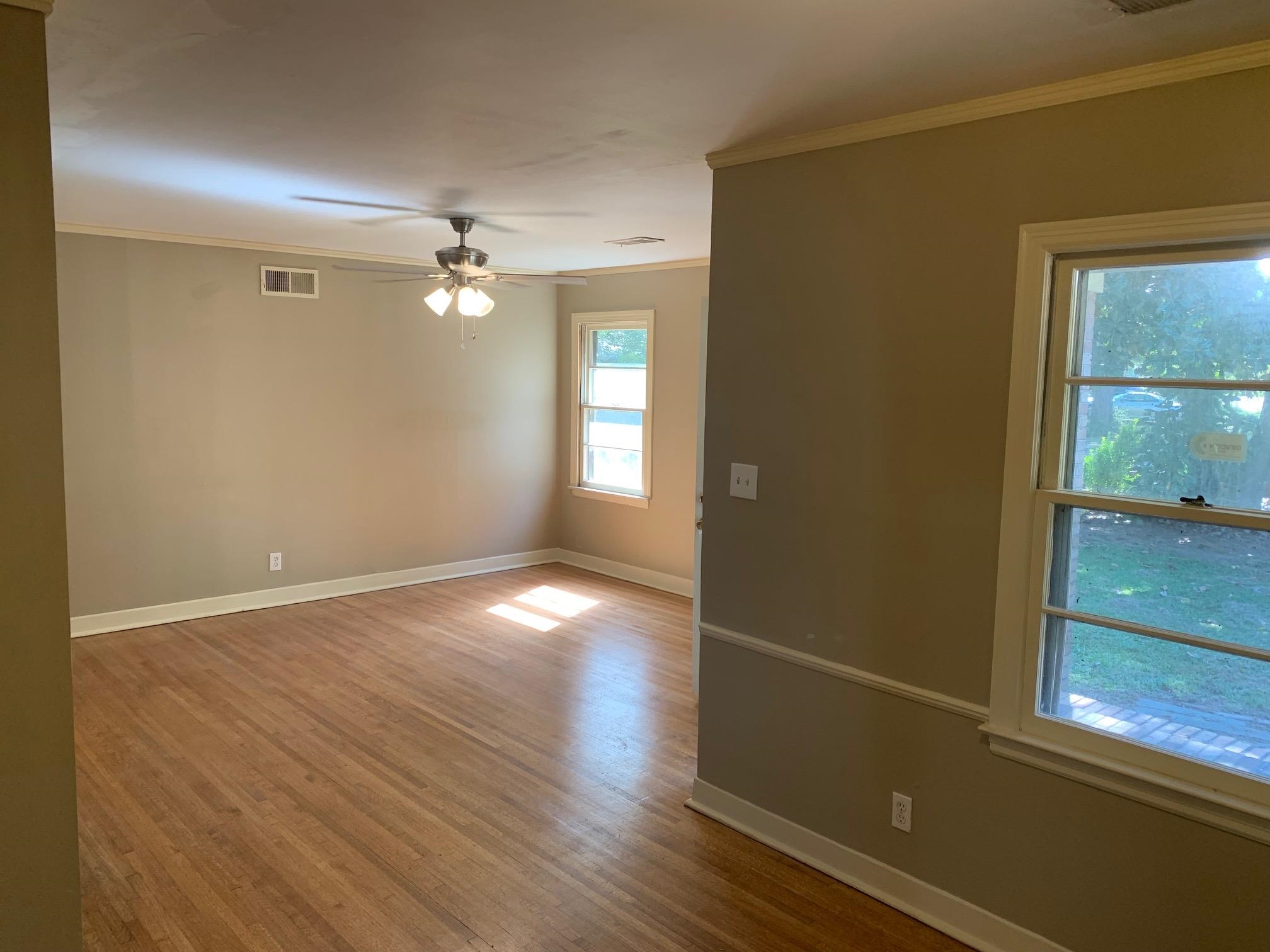 1640 South Perkins Road Memphis, TN 38117 - Photo 5 of 10 an empty room with wooden floor and windows