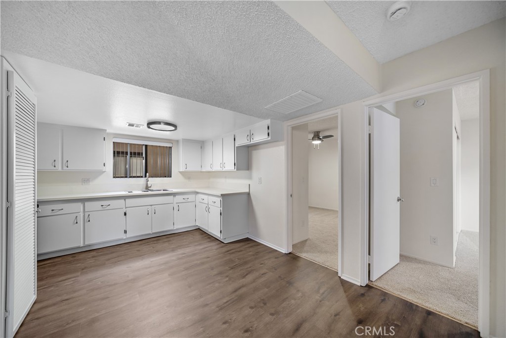 1349 Elm Avenue San Gabriel, CA 91775 - Photo 3 of 10 a large white kitchen with white cabinets and wooden floor