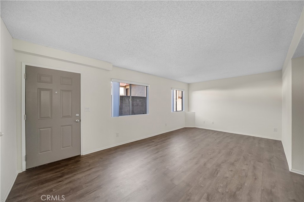 1349 Elm Avenue San Gabriel, CA 91775 - Photo 4 of 10 an empty room with wooden floor and windows