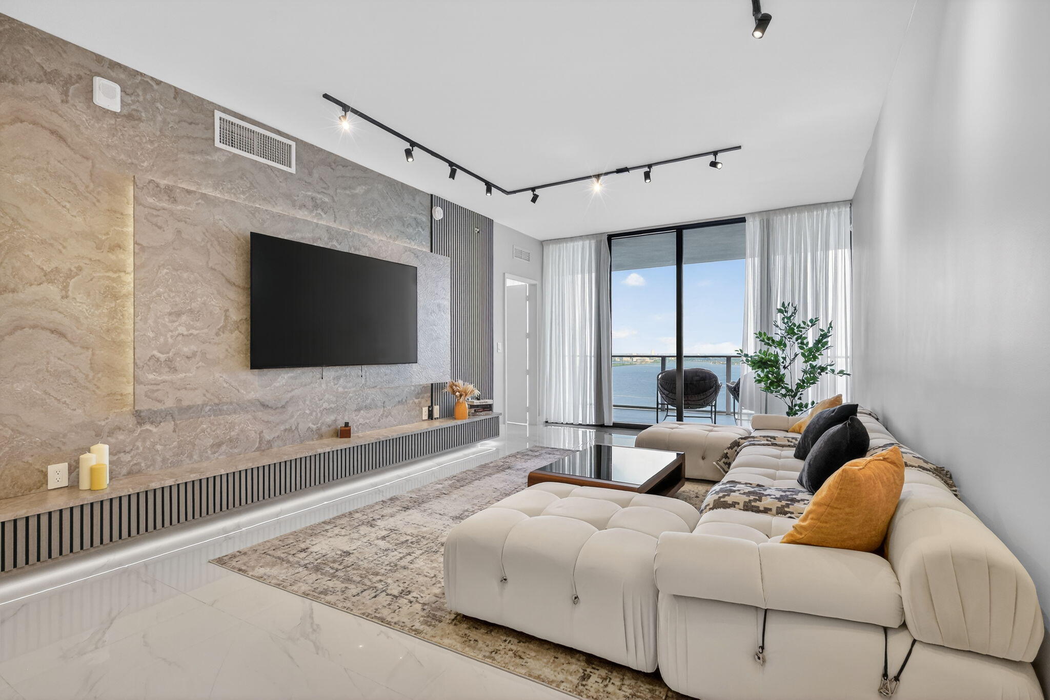 700 Northeast 23rd Street, Unit 3206 Miami, FL 33137 - Photo 1 of 37 a living room with furniture and a flat screen tv