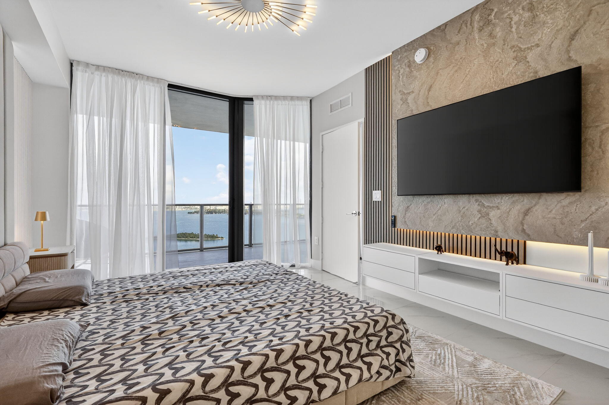 700 Northeast 23rd Street, Unit 3206 Miami, FL 33137 - Photo 13 of 37 a bedroom with a bed and a flat screen tv