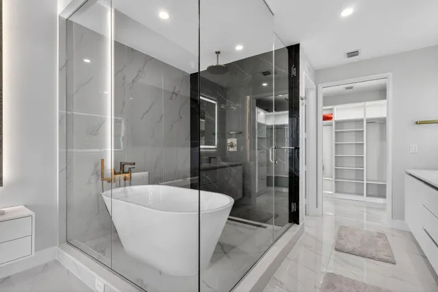 a bathroom with a bathtub and shower