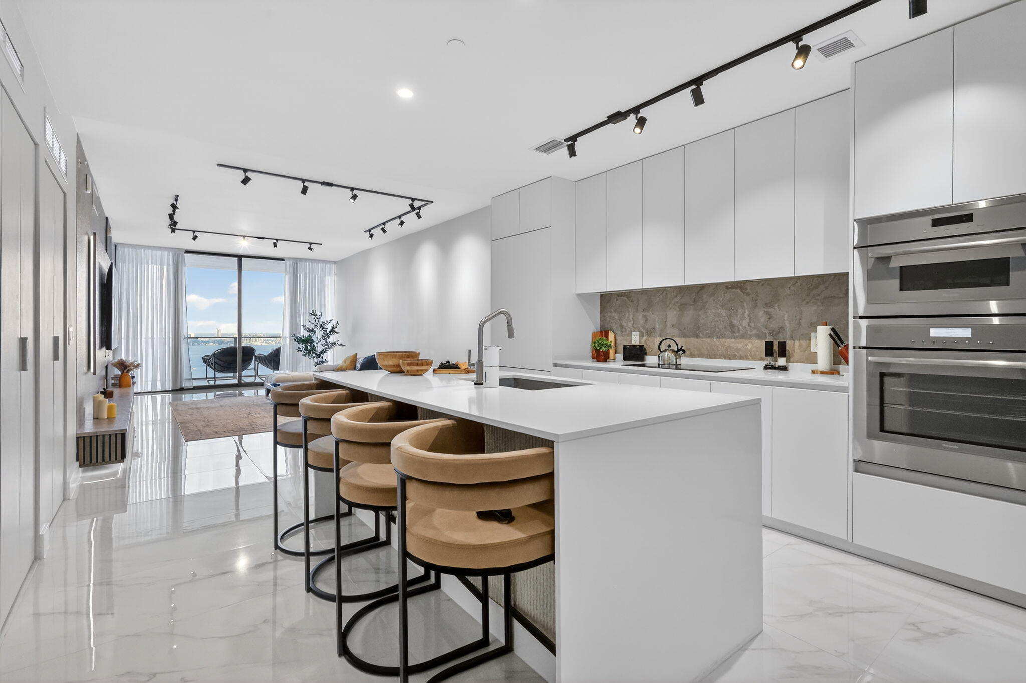 700 Northeast 23rd Street, Unit 3206 Miami, FL 33137 - Photo 2 of 37 a kitchen with a table chairs refrigerator and cabinets