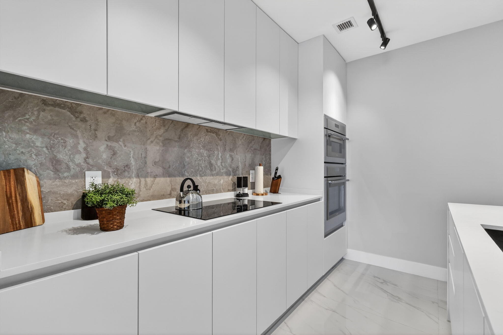 700 Northeast 23rd Street, Unit 3206 Miami, FL 33137 - Photo 5 of 37 a kitchen with sink and cabinets