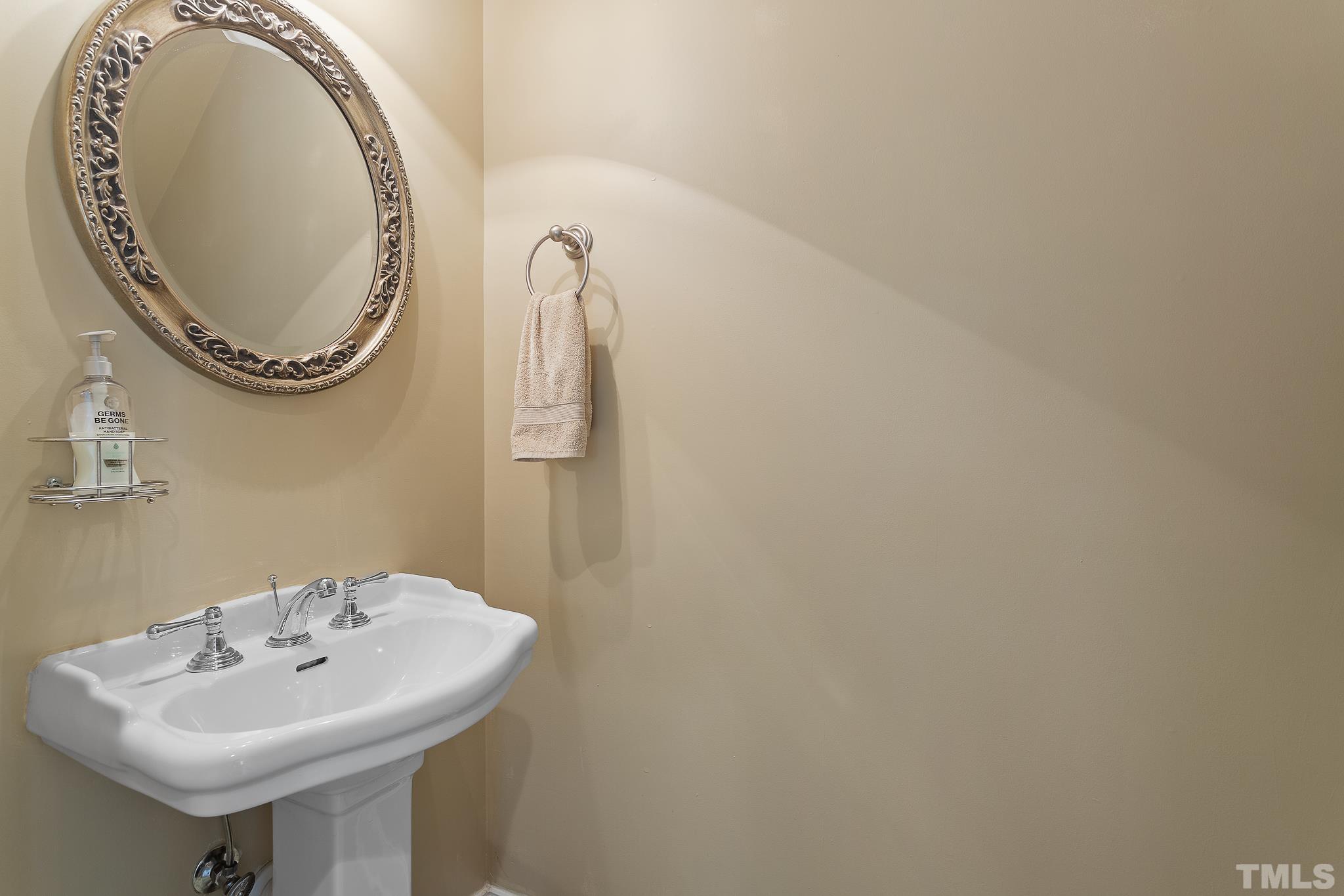 7708 Alexander Promenade Place Raleigh, NC 27617 - Photo 15 of 27 a bathroom with a sink and a mirror