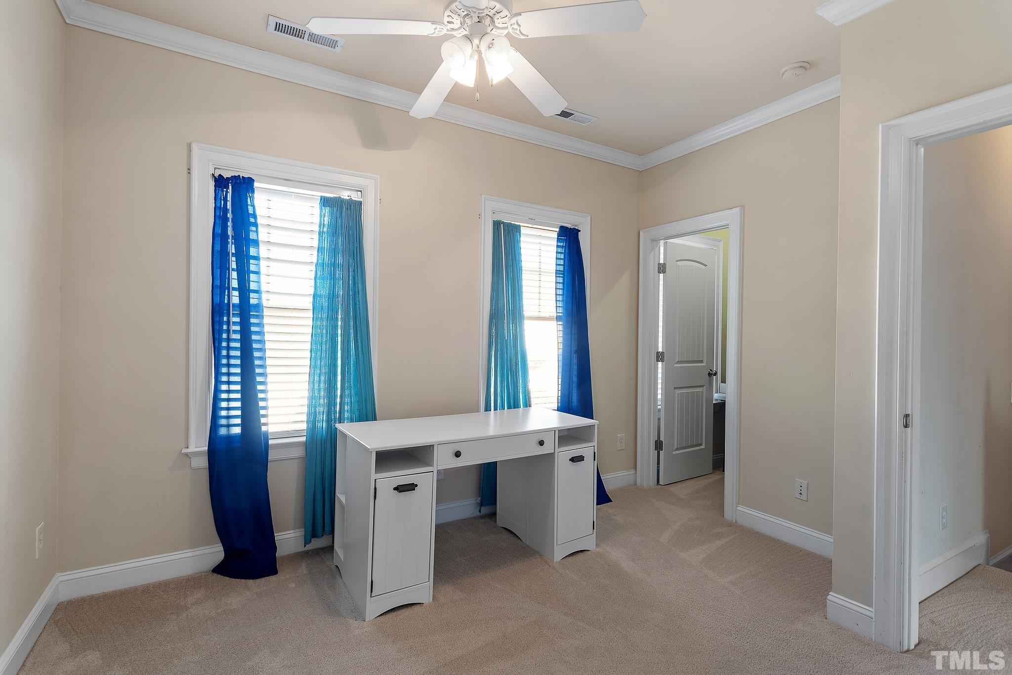 7708 Alexander Promenade Place Raleigh, NC 27617 - Photo 20 of 27 a room with a window and a chandelier fan