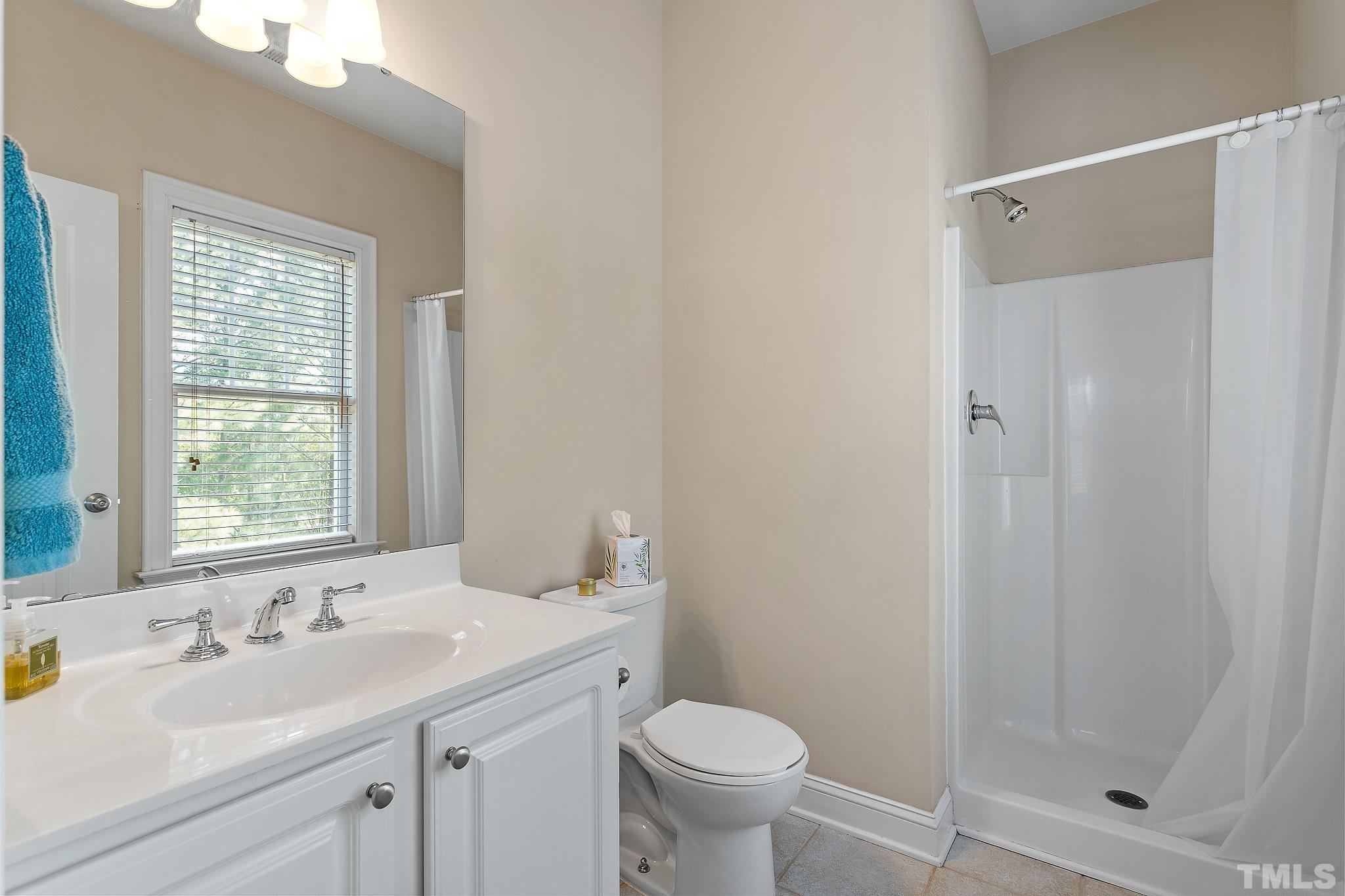 7708 Alexander Promenade Place Raleigh, NC 27617 - Photo 21 of 27 a bathroom with a sink toilet and shower