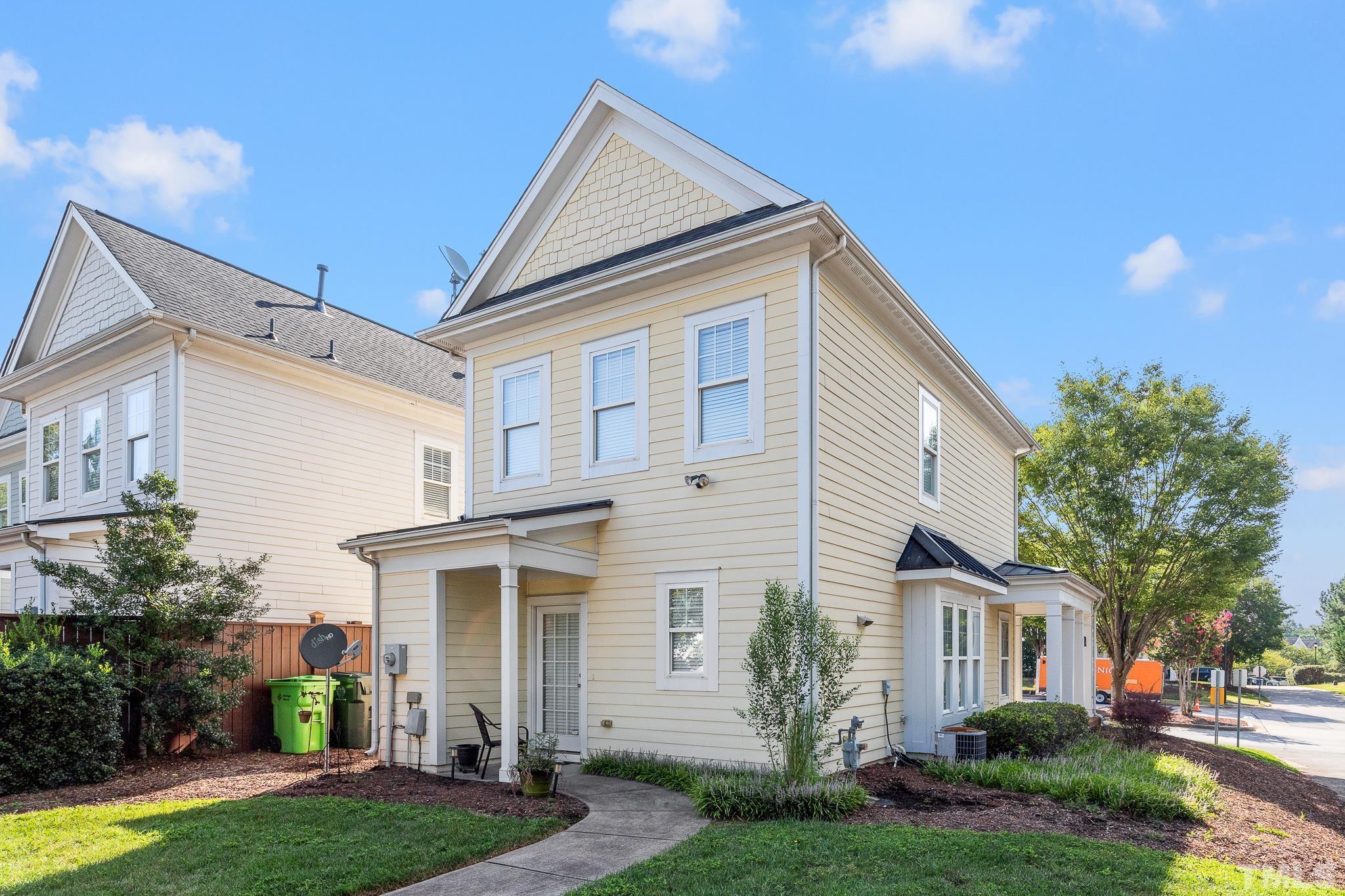 7708 Alexander Promenade Place Raleigh, NC 27617 - Photo 27 of 27 a front view of a house with a yard and garage
