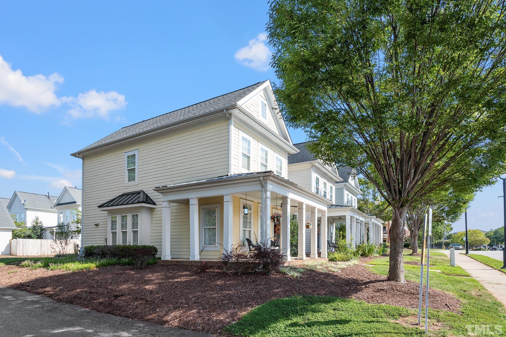 7708 Alexander Promenade Place Raleigh, NC 27617 - Photo 4 of 27 a front view of a house with a yard