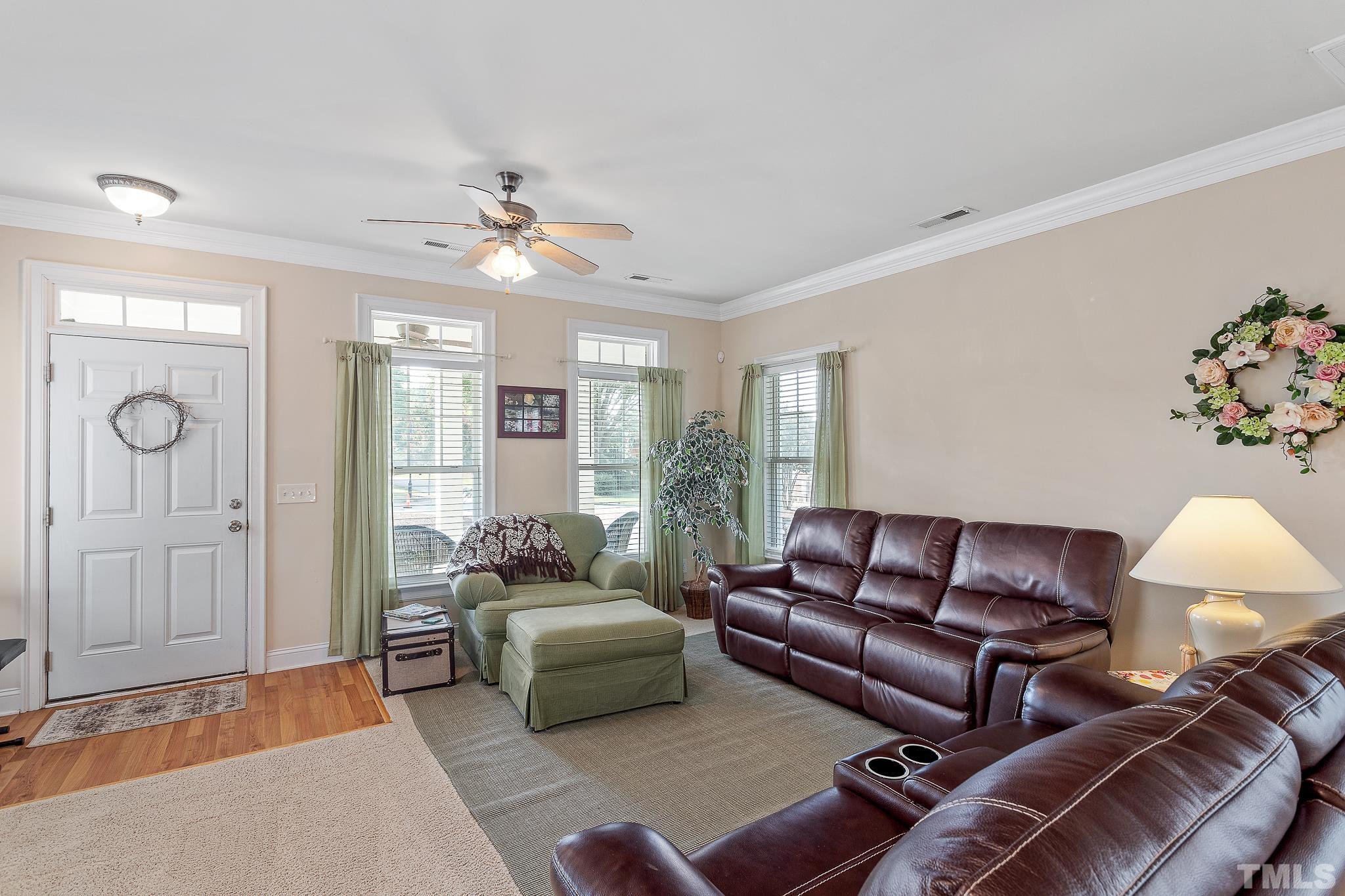7708 Alexander Promenade Place Raleigh, NC 27617 - Photo 6 of 27 a living room with furniture ceiling fan and a rug