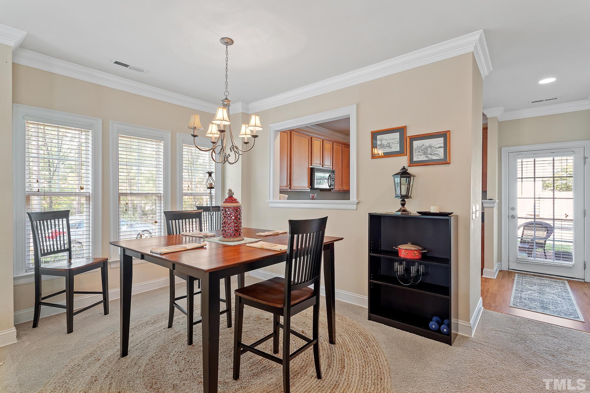 7708 Alexander Promenade Place Raleigh, NC 27617 - Photo 9 of 27 a dining room with furniture and window