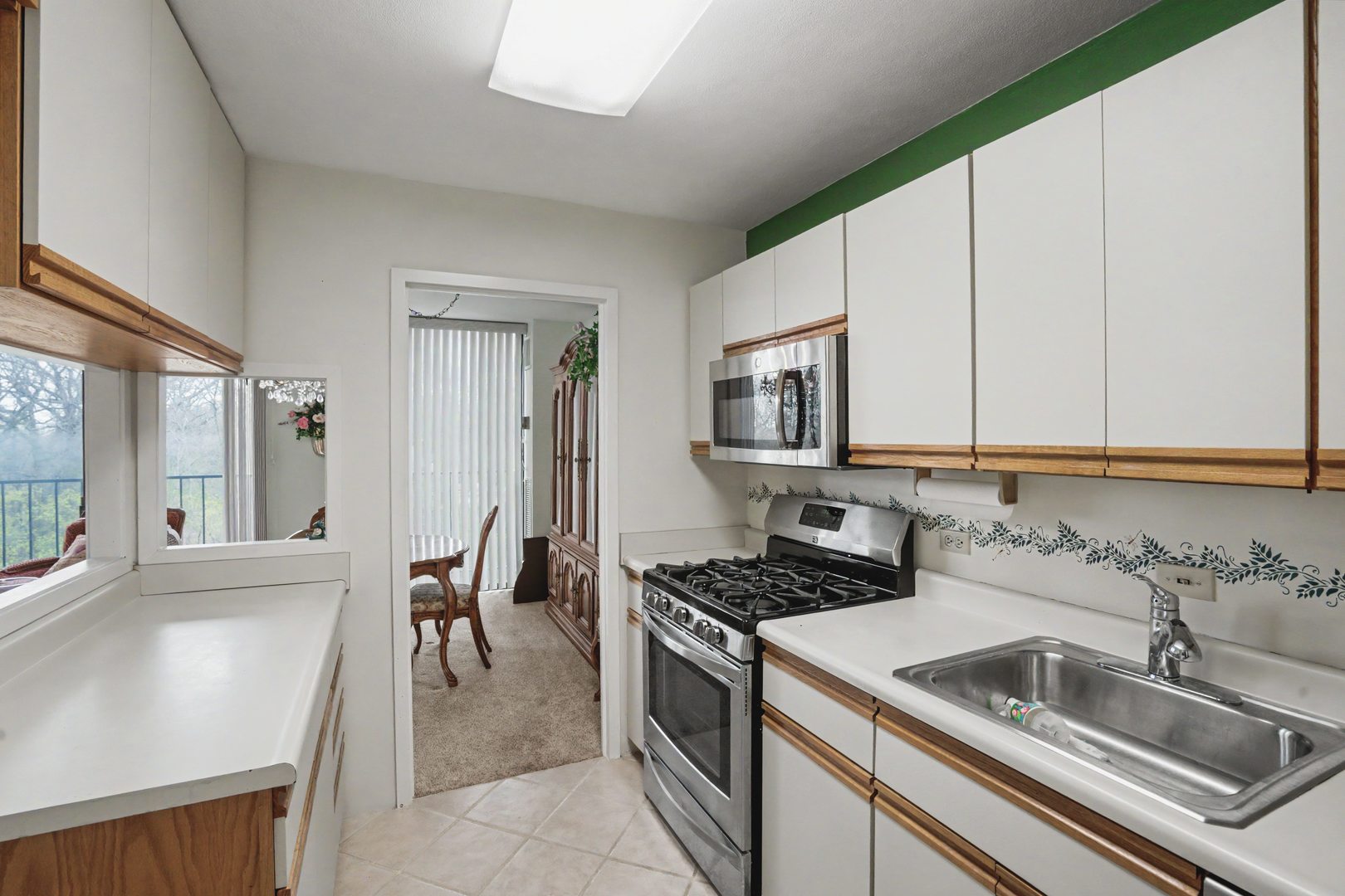 1800 7th Street, Unit 5D East Moline, IL 61244 - Photo 11 of 24 a kitchen that has a sink and a stove