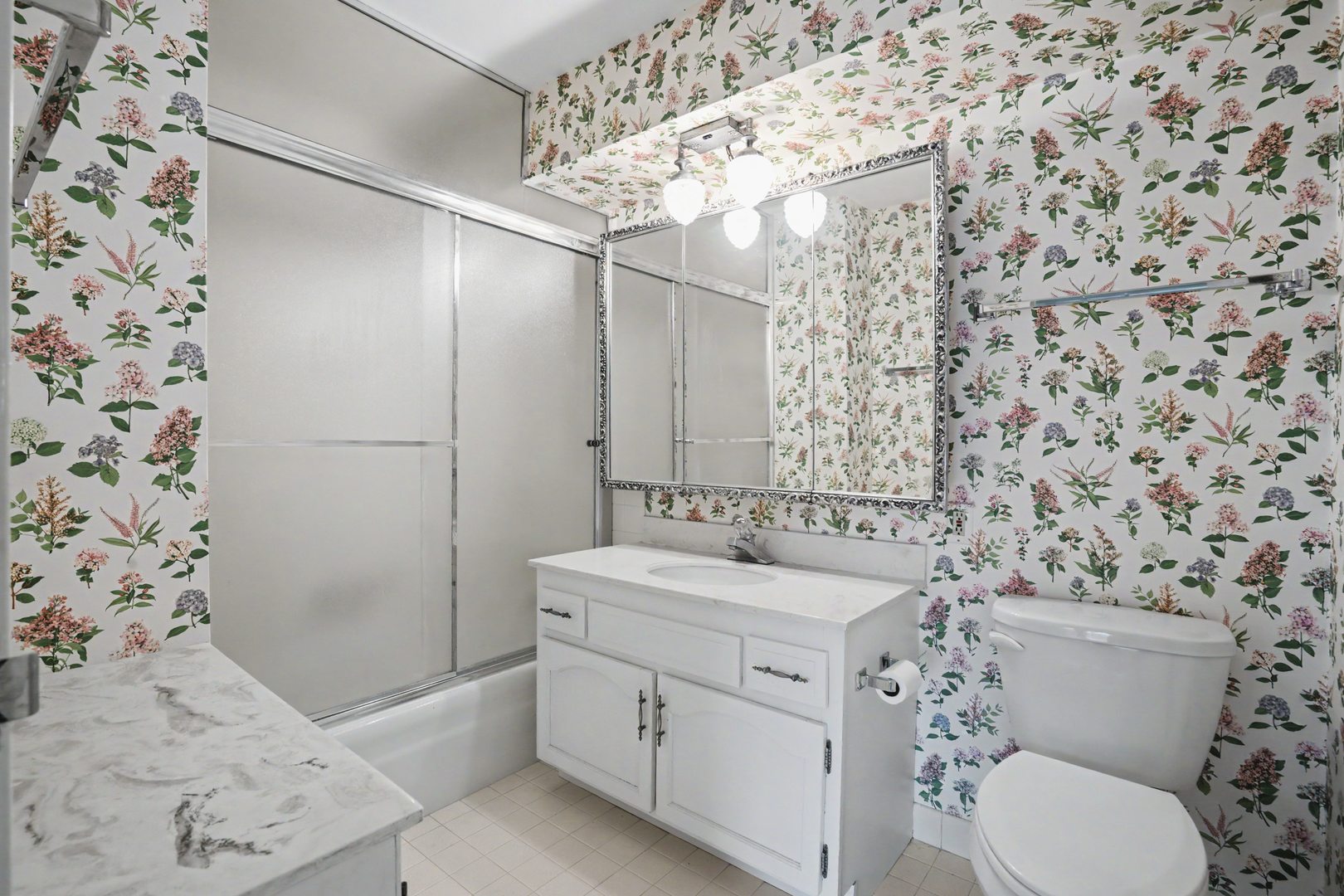 1800 7th Street, Unit 5D East Moline, IL 61244 - Photo 12 of 24 a bathroom with a sink toilet vanity and shower