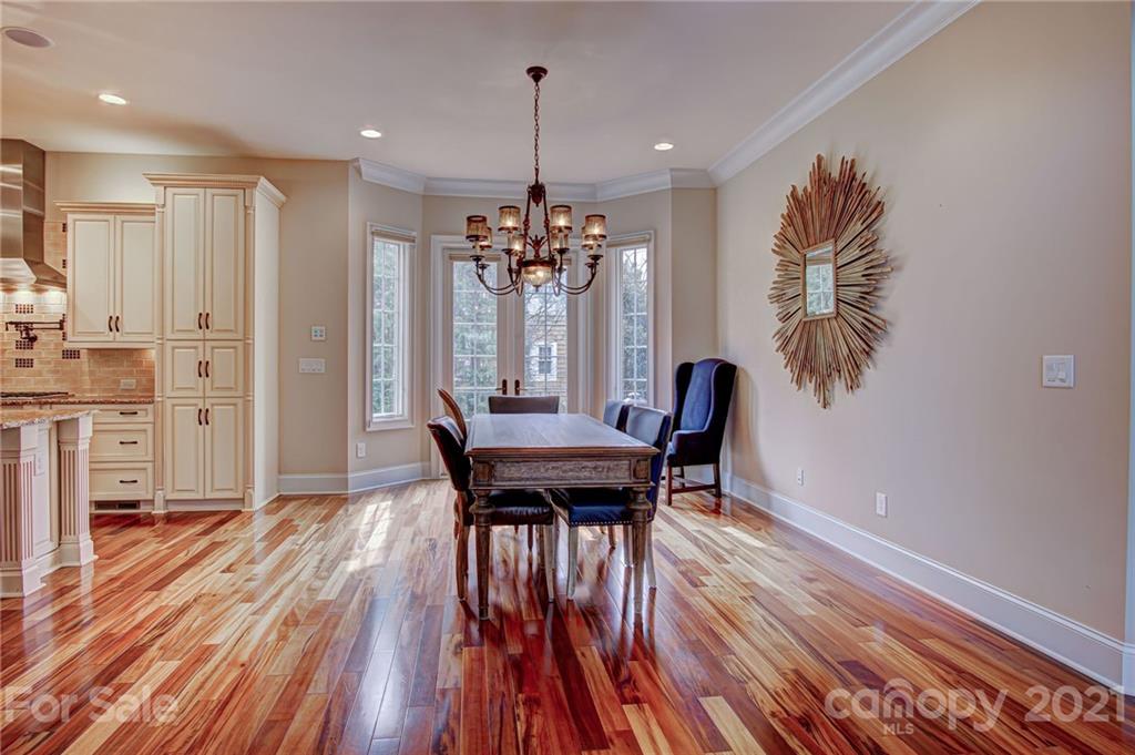2105 South Wendover Road Charlotte, NC 28211 - Photo 16 of 46 a view of a dining room with furniture and wooden floor