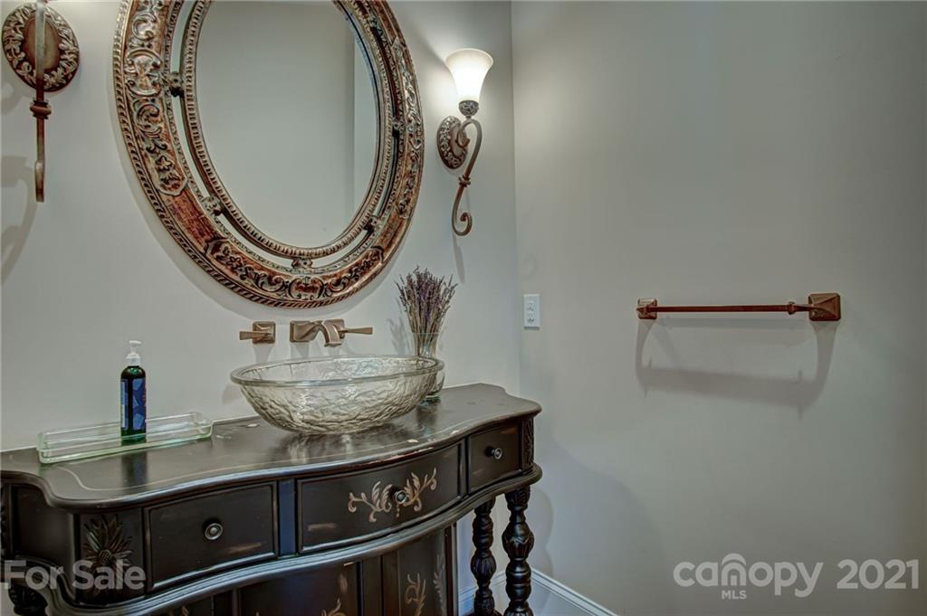 2105 South Wendover Road Charlotte, NC 28211 - Photo 17 of 46 a close view of light fixtures and a mirror on a table