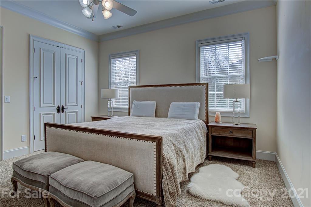 2105 South Wendover Road Charlotte, NC 28211 - Photo 33 of 46 a bedroom with a bed and a chandelier