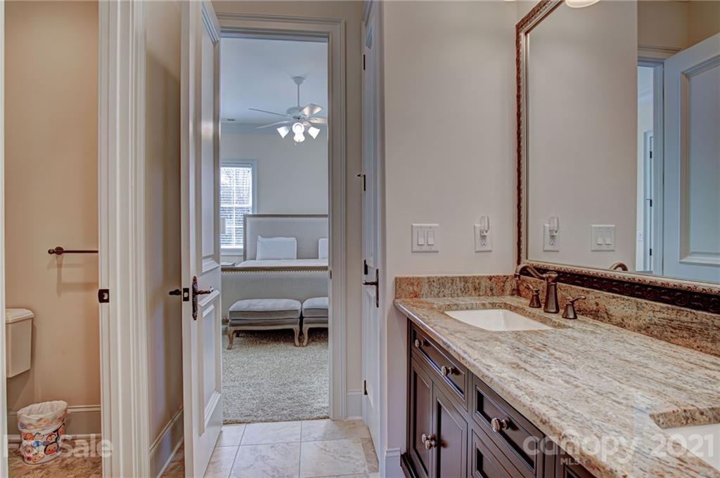 2105 South Wendover Road Charlotte, NC 28211 - Photo 34 of 46 a en suite bathroom with a granite countertop sink and a mirror