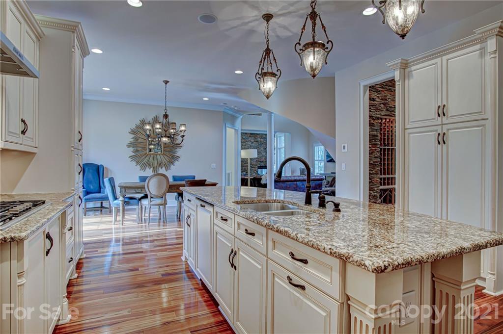 2105 South Wendover Road Charlotte, NC 28211 - Photo 10 of 46 a kitchen with stainless steel appliances granite countertop a kitchen island a stove and a wooden floors