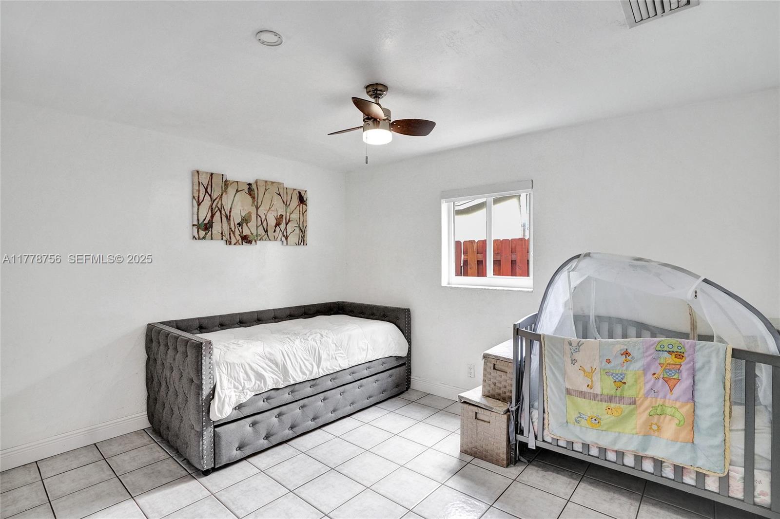 4185 Southwest 49th Court Dania Beach, FL 33314 - Photo 12 of 21 a bedroom with a bed and a painting on the wall