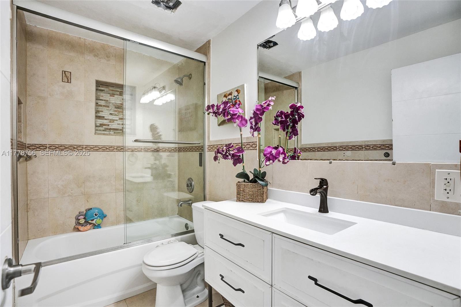 4185 Southwest 49th Court Dania Beach, FL 33314 - Photo 15 of 21 a bathroom with a sink a toilet and a mirror