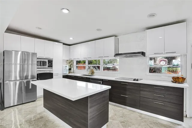 a kitchen with a refrigerator sink and wooden cabinets