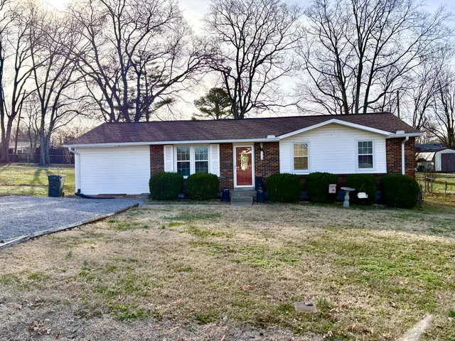 a house that has a tree in front of it