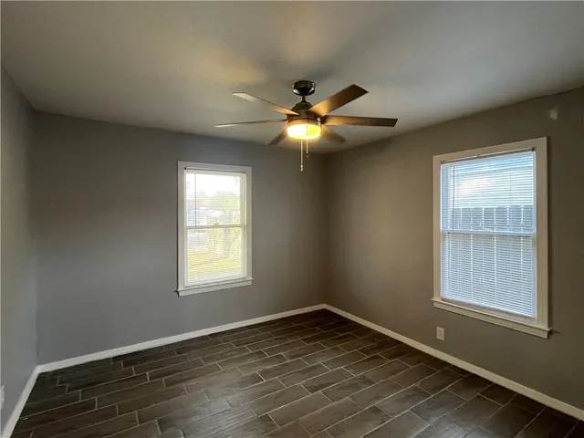 a view of an empty room with wooden floor