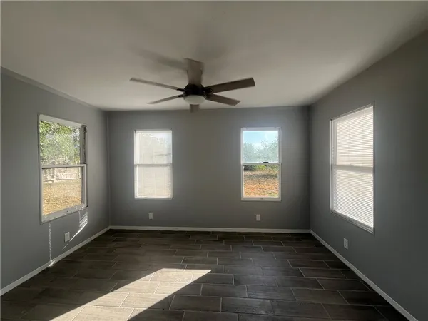 a view of a livingroom with a ceiling fan and window