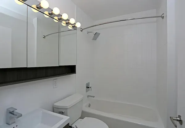a bathroom with a toilet a sink and bathtub