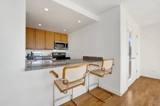 a view of kitchen with cabinets and wooden floor