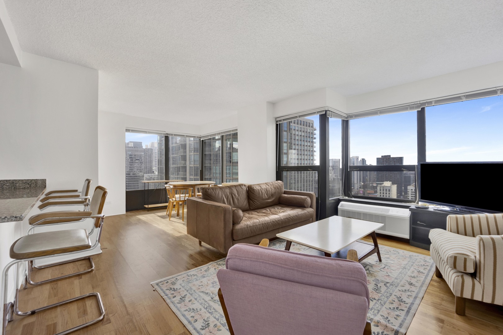30 East Huron Street, Unit 3204 Chicago, IL 60611 - Photo 7 of 17 a living room with furniture and a flat screen tv