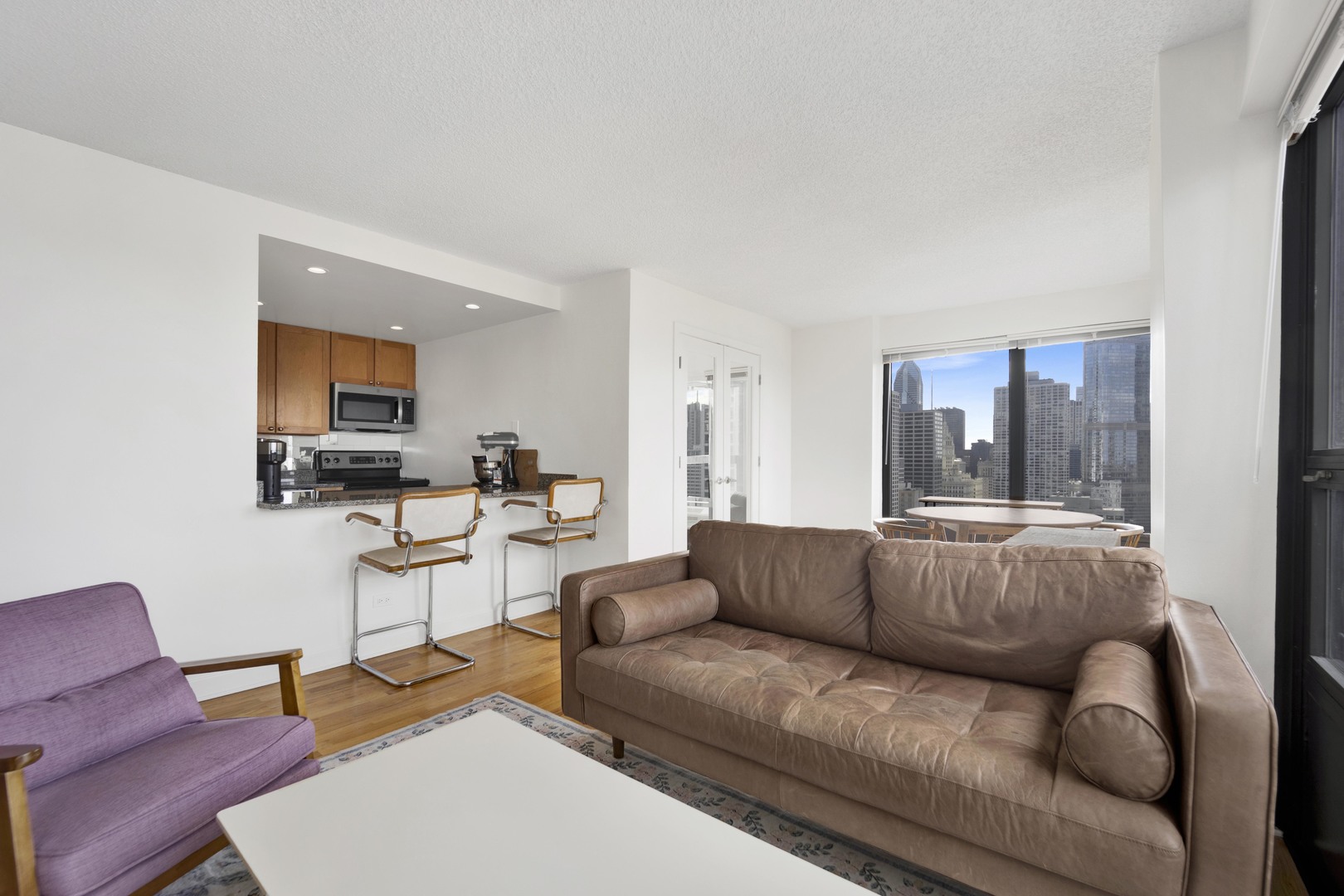 30 East Huron Street, Unit 3204 Chicago, IL 60611 - Photo 8 of 17 a living room with furniture and a window